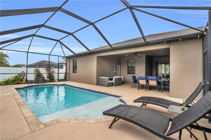 View of pool featuring a patio, a lanai, and ceiling fan