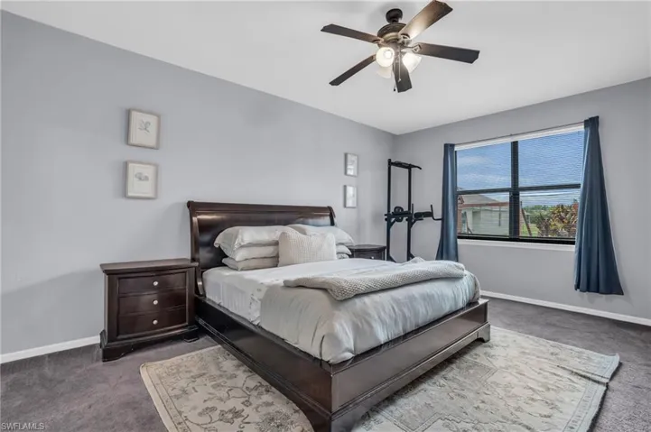Bedroom featuring ceiling fan and carpet flooring