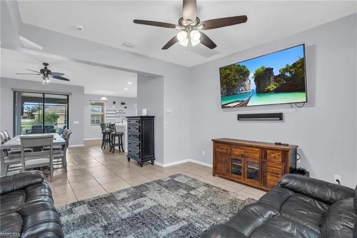 Tiled living room featuring ceiling fan
