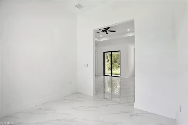 Tiled spare room with ceiling fan