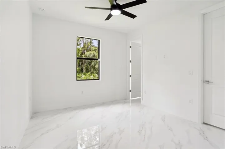 Unfurnished room featuring ceiling fan and tile floors