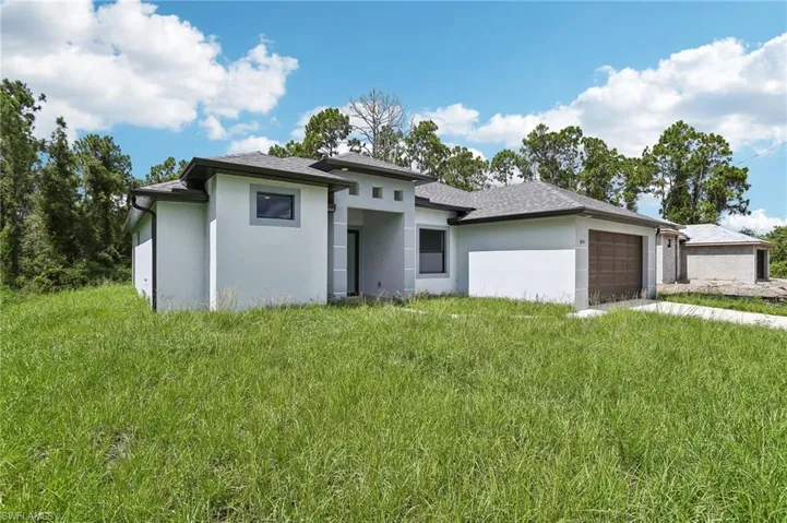 Prairie-style house with a garage and a front yard