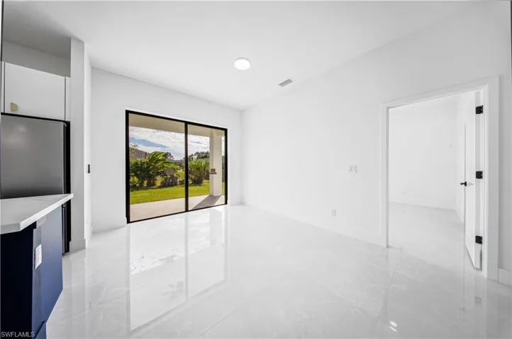 Unfurnished living room with baseboards