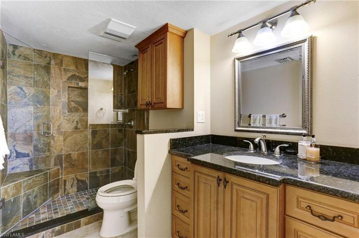 Primary bathroom with custom tiled shower, glass shower door, granite vanities!
