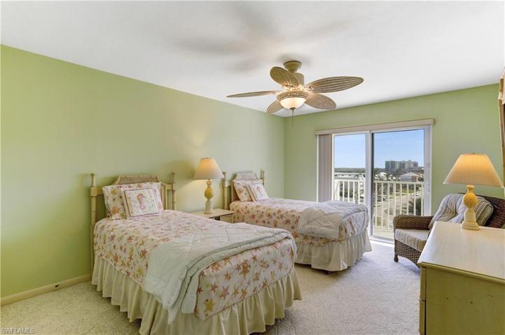 Spacious guest bedroom with impact sliders out to shared open balcony!