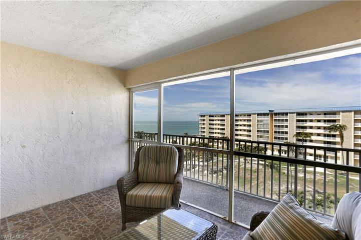 Screened front balcony complete with newer tile and patio furniture!