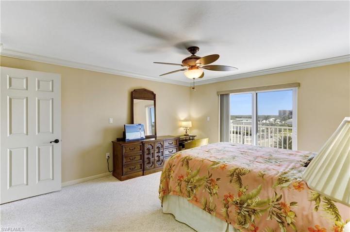 Spacious primary bedroom with impact sliders out to open  back balcony!