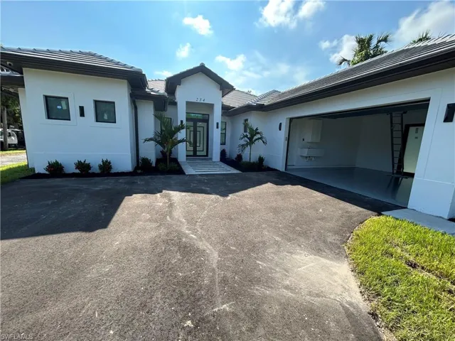 View of front facade featuring a garage