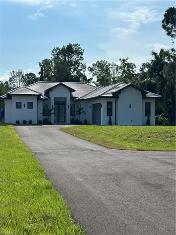 Ranch-style home with a front lawn