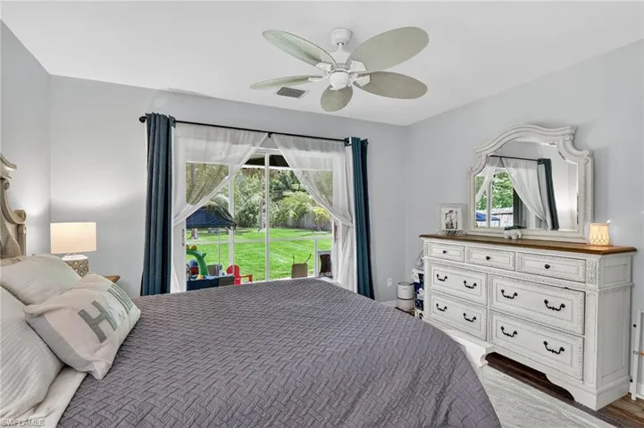 Bedroom with access to outside and a ceiling fan