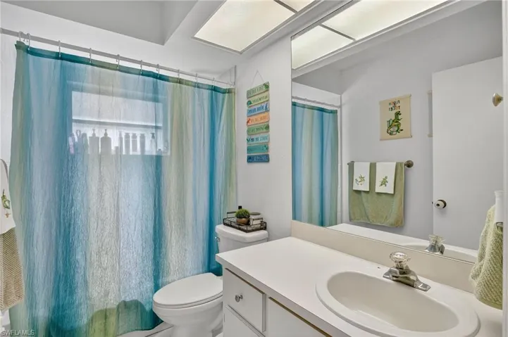 Bathroom with vanity and a shower with shower curtain