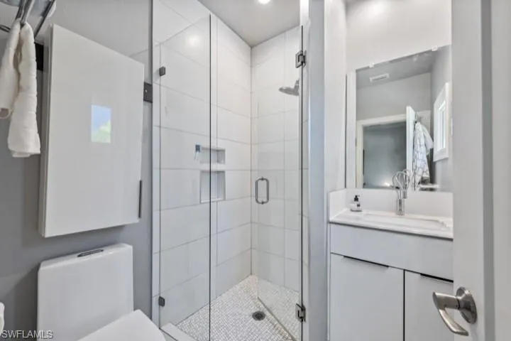 Master-Bathroom with vanity, a shower with shower door, and toilet