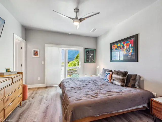Bedroom with ceiling fan, access to outside, and light hardwood / wood-style floors