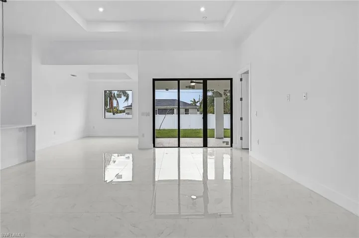 Unfurnished room featuring a tray ceiling