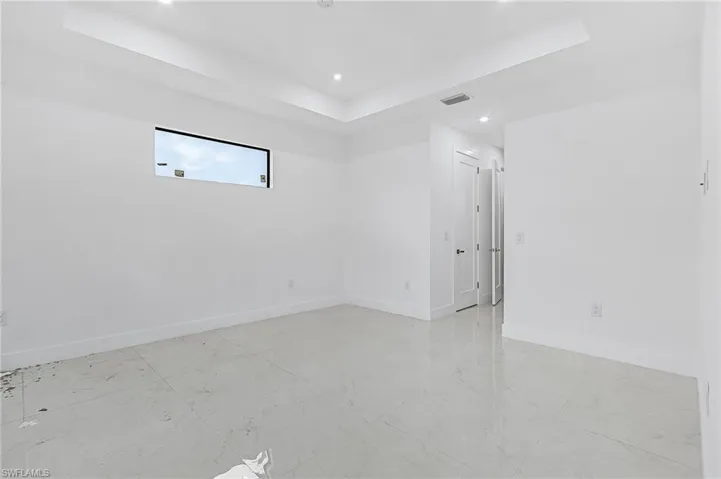 Empty room featuring a raised ceiling