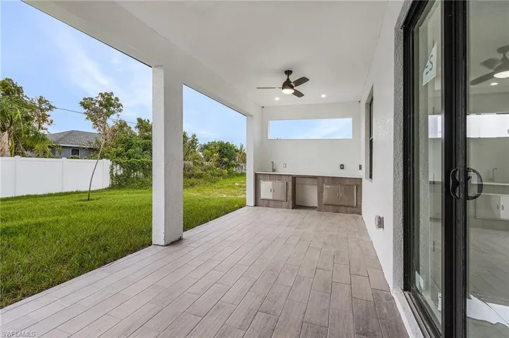 View of patio / terrace with ceiling fan and an outdoor kitchen
