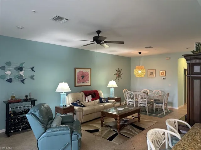 Open-concept living area featuring tile flooring, a ceiling fan, and recessed lighting
