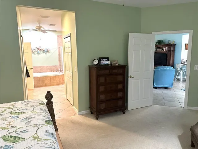 Bedroom featuring light green wall paint and carpet flooring