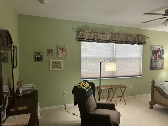 Soft green walls complement the neutral tone carpet and window treatments