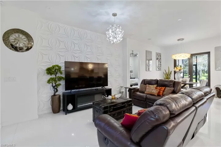 Living area with a chandelier and tile patterned floors