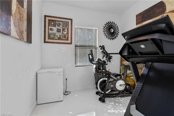 Workout room featuring baseboards and tile patterned flooring
