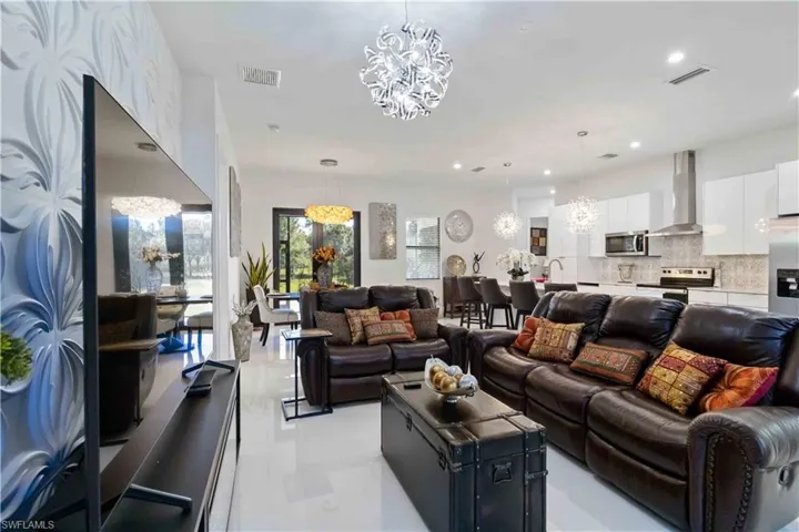 Living area featuring a chandelier, recessed lighting, and light tile patterned floors