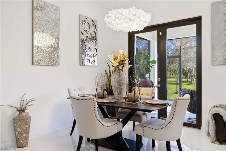 Dining space with a chandelier and light tile patterned flooring