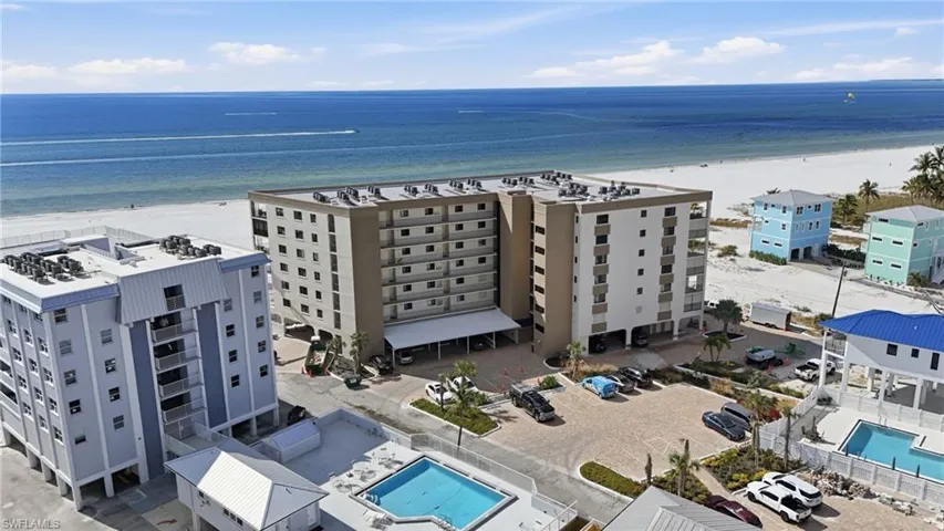 Drone / aerial view of a pool area and apartment complex