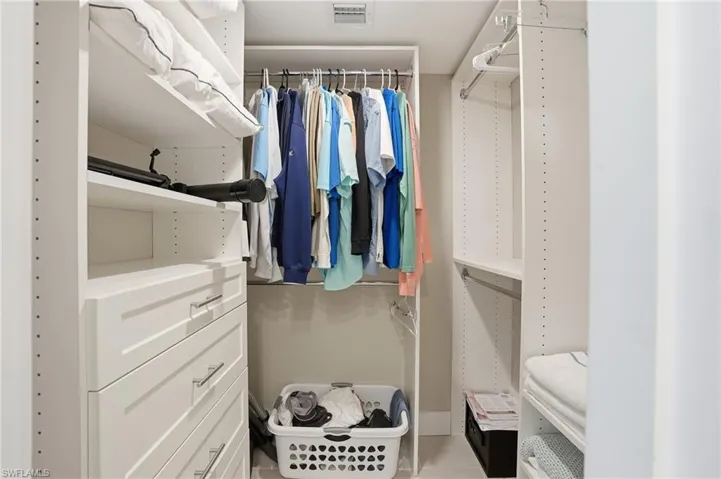Spacious closet with light tile patterned floors