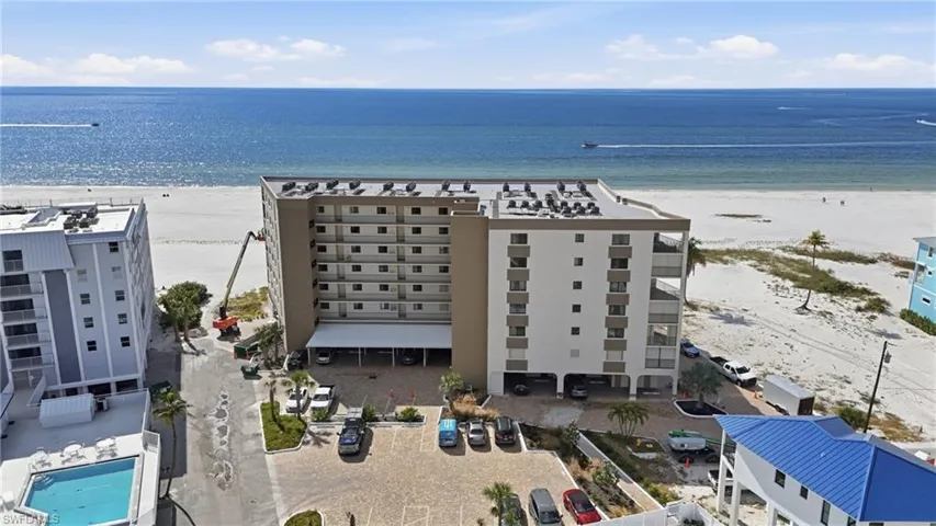 Bird's eye view of apartment complex / building and extended coastline