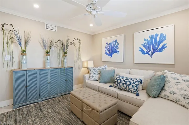 Living room with ornamental molding, recessed lighting, and a ceiling fan
