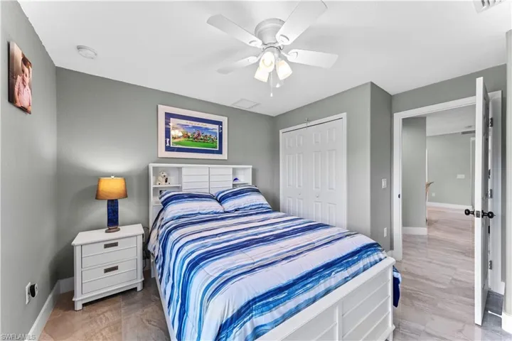 Bedroom featuring light hardwood / wood-style floors, a closet, and ceiling fan