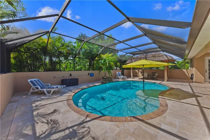 View of swimming pool featuring a lanai and a patio area