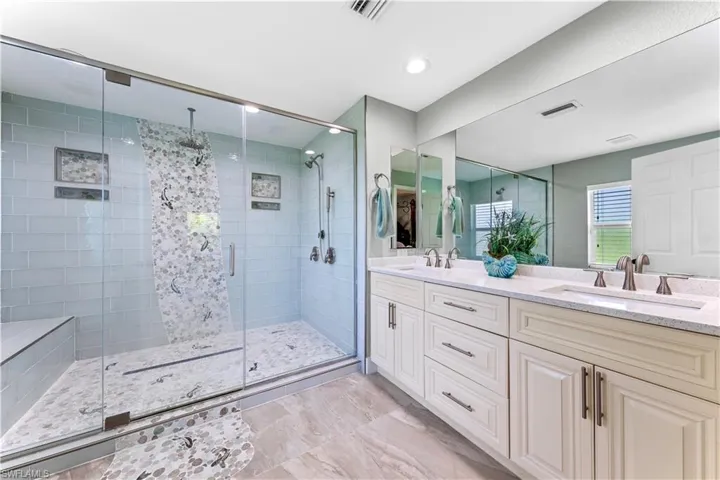 Bathroom featuring walk in shower and vanity