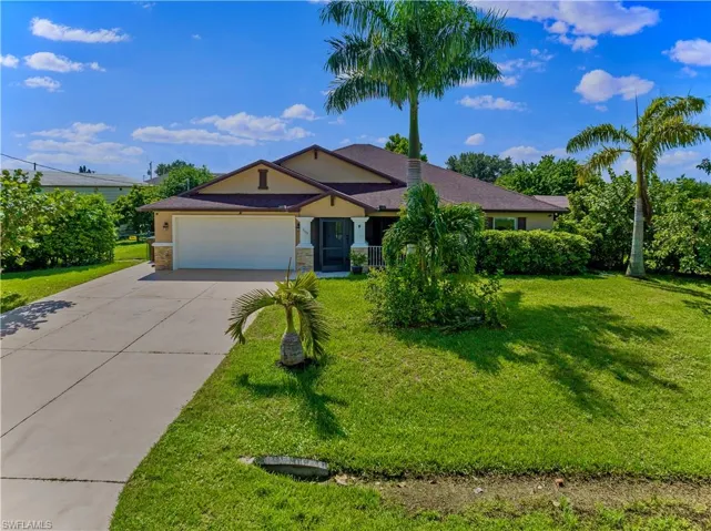 Ranch-style house featuring a front yard and a garage