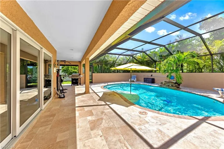 View of pool featuring a lanai, a patio, ceiling fan, and a grill