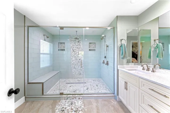 Bathroom featuring vanity and a shower with shower door