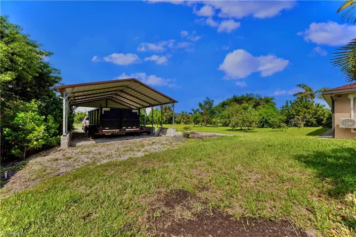 View of yard with a carport