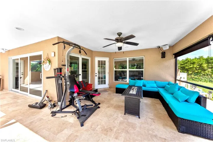 View of patio featuring an outdoor living space and ceiling fan