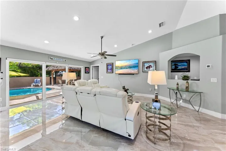 Living room featuring lofted ceiling and ceiling fan