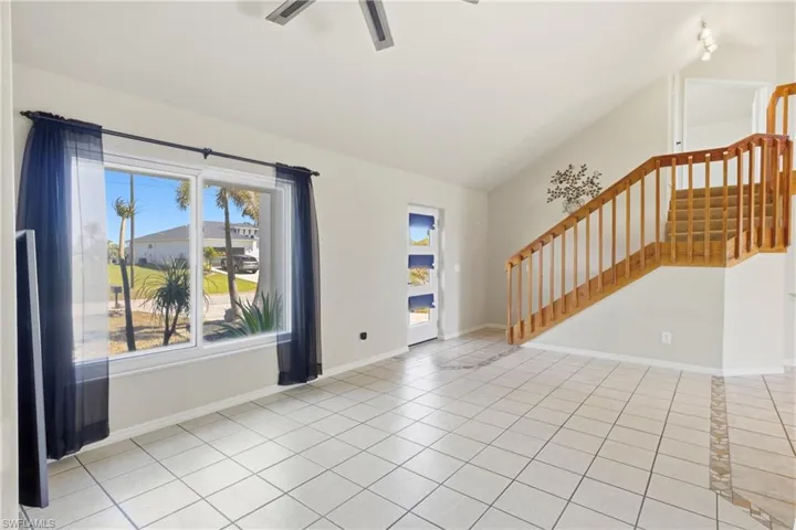 Step through the front door into a grand, light-filled entryway where soaring ceilings and abundant natural light.