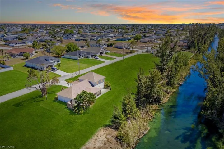 From above, the beauty unfolds—this waterfront property showcases serene canal views, tropical greenery, and the ultimate private outdoor escape.