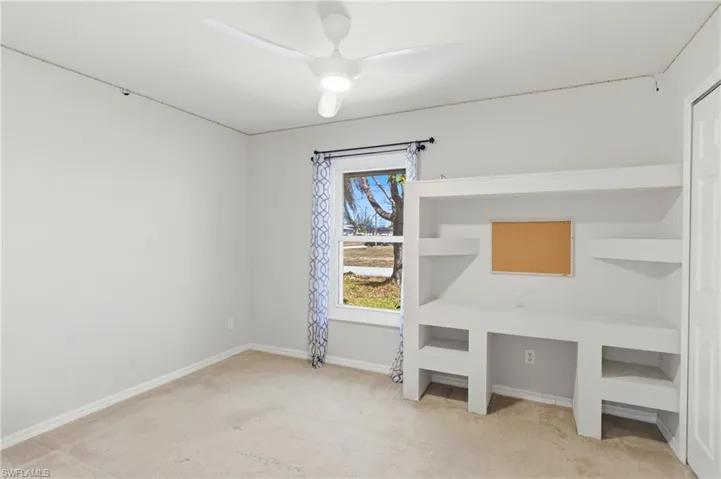 Charming guest bedroom with custom built-in shelves, offering both storage and style—perfect for family, friends, or a quiet home office.
