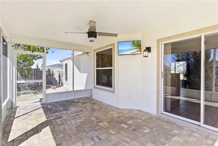 Your private oasis—lanai overlooking the canal with vibrant tropical plants and endless Florida sunsets.