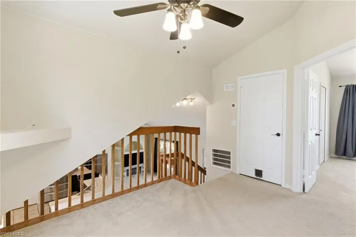An airy, versatile loft space overlooking the living area, ideal for a home office, media room, or bonus lounge.