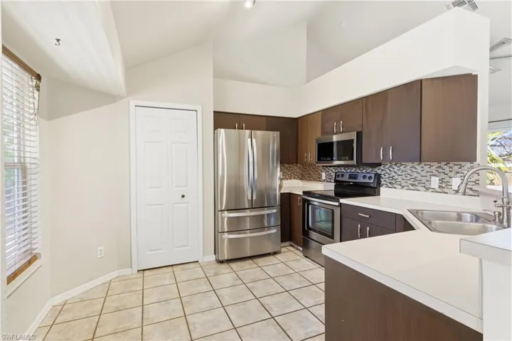 A beautiful, sunlit kitchen with plenty of prep space, custom cabinetry, and easy access to the dining area, making every meal an experience.
