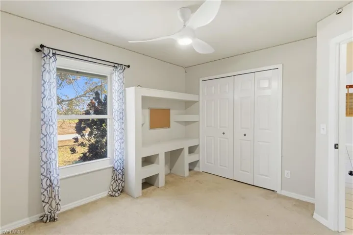 Inviting guest room featuring thoughtfully designed built-in shelving, providing functionality and character for every need.