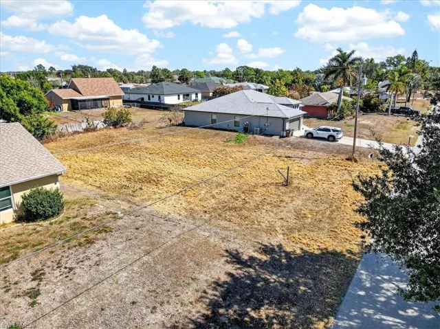 View of yard featuring a residential view and driveway