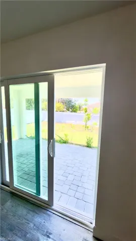 Sliding glass door leading to an outdoor paver patio