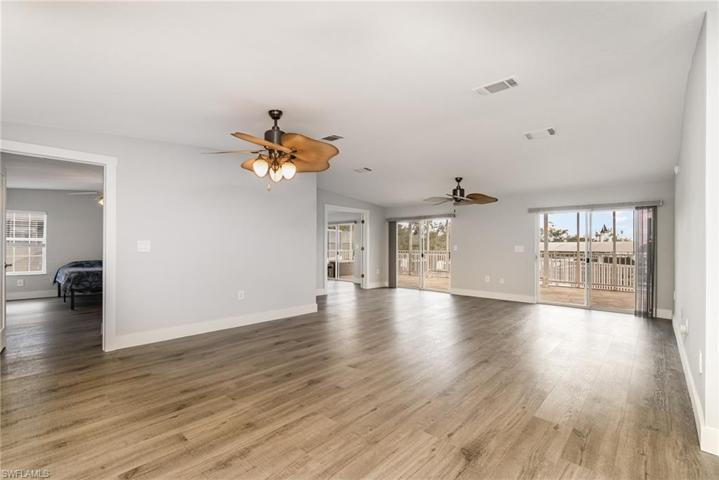 Great room with open concept to kitchen and dining area. Primary bedroom on left